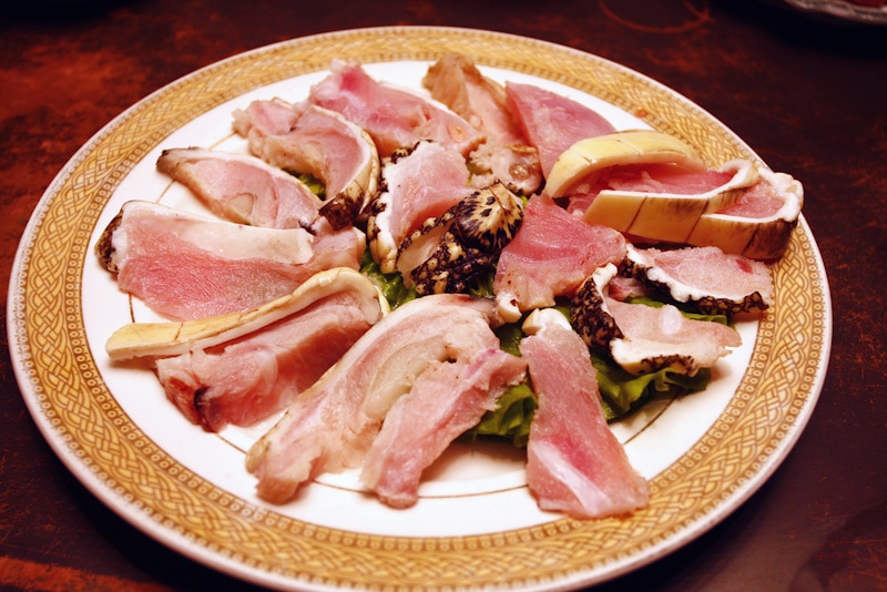 Slices of alligator meat arranged on a plate