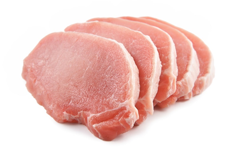 Slices of pork loin on white background