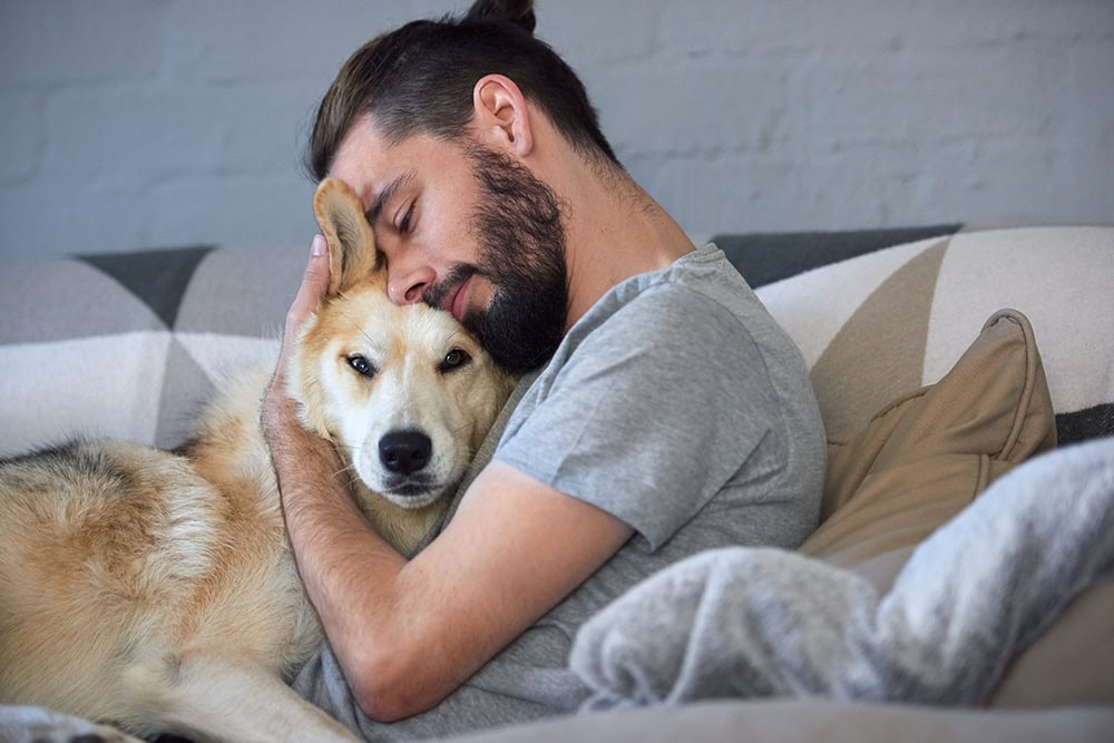 bearded man hugging his dog