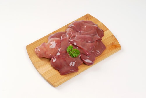 raw chicken liver on wooden cutting board