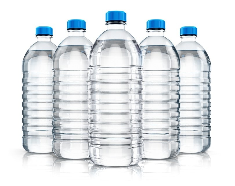 five plastic bottles with clear water