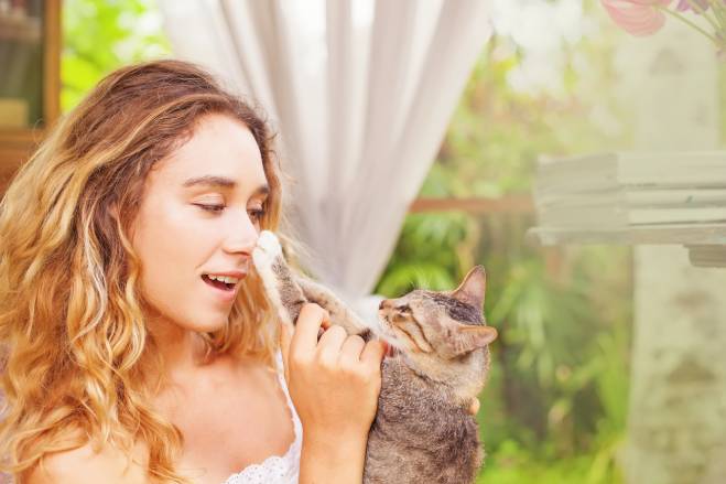 Cat Paws on girl's nose