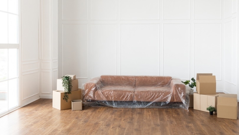 Couch covered in plastic