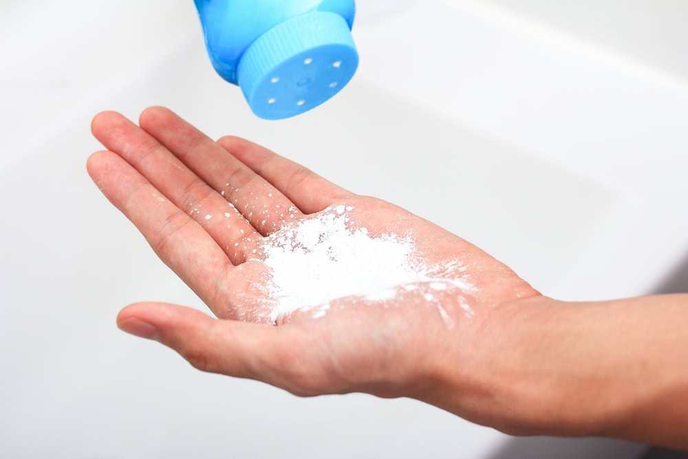 applying talcum powder on hand