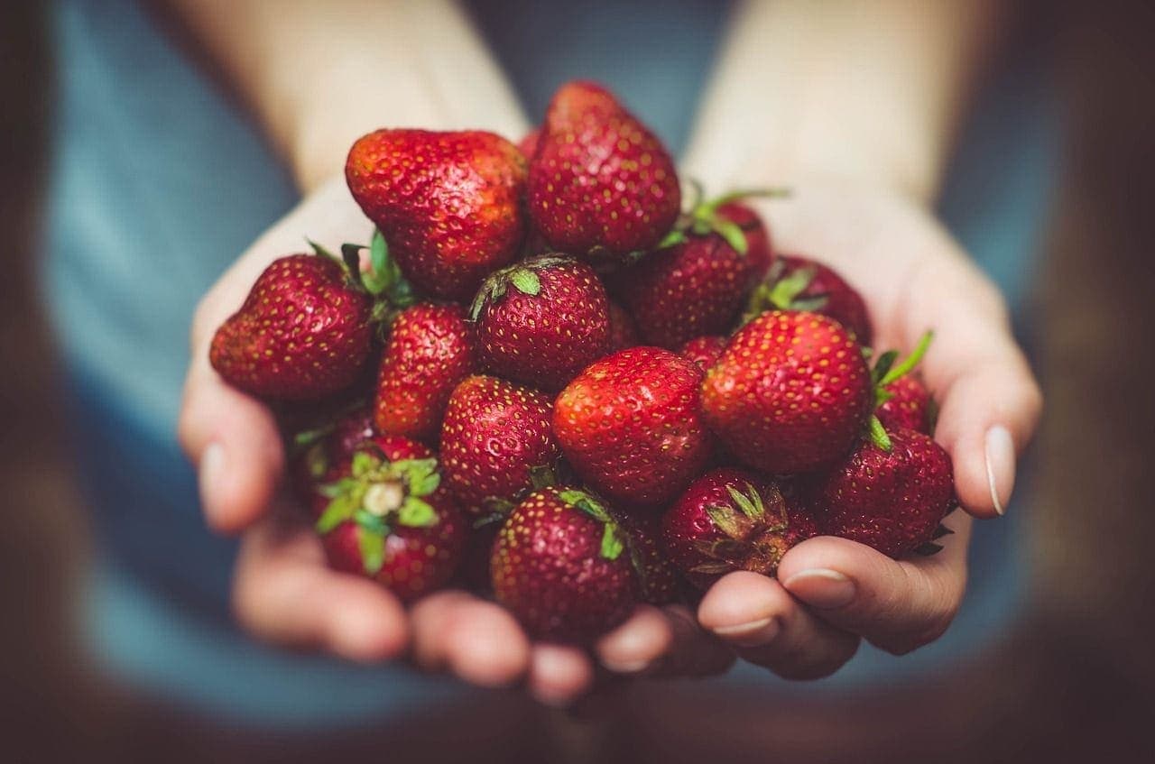 handing over strawberries