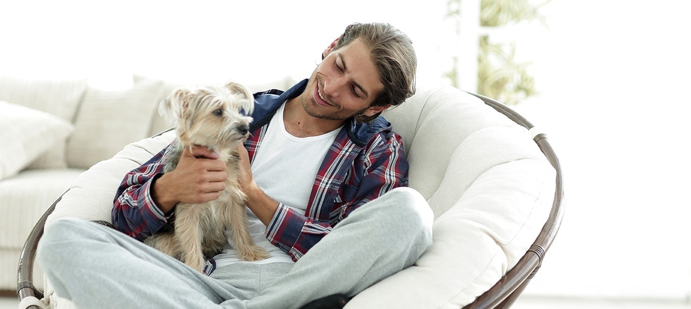 man cuddling a dog