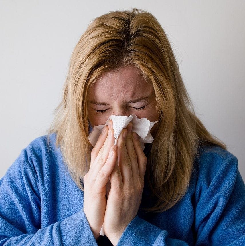 woman sneezing