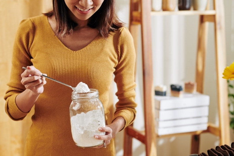 woman holding a jar of baking soda