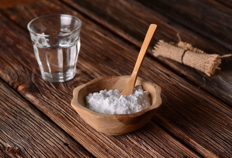 baking soda into the bowl with wooden spoon
