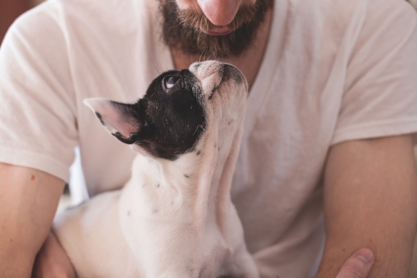 man holding his pet dog
