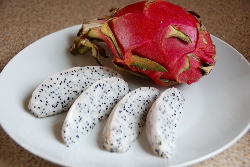 sliced dragon fruit on white plate