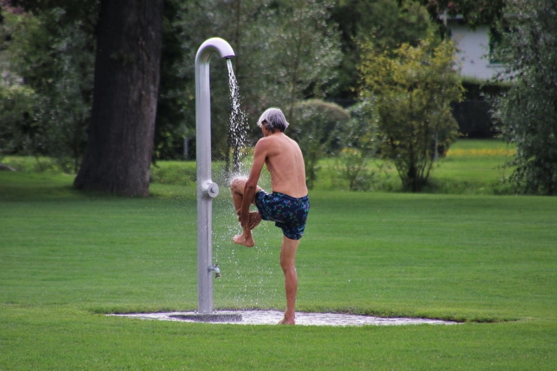 Man taking a shower outdoor