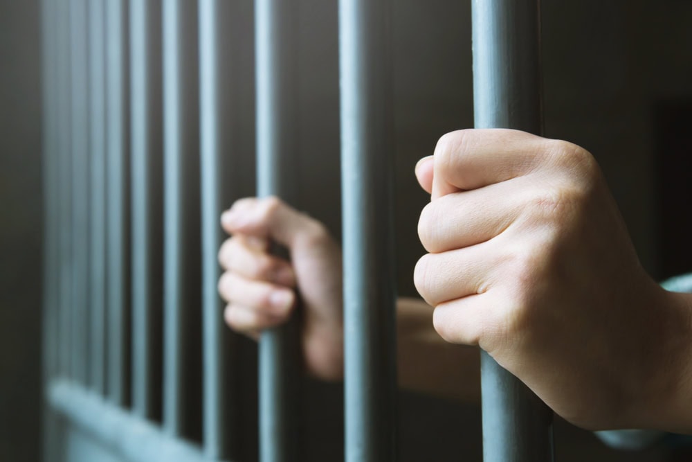man behind prison bars