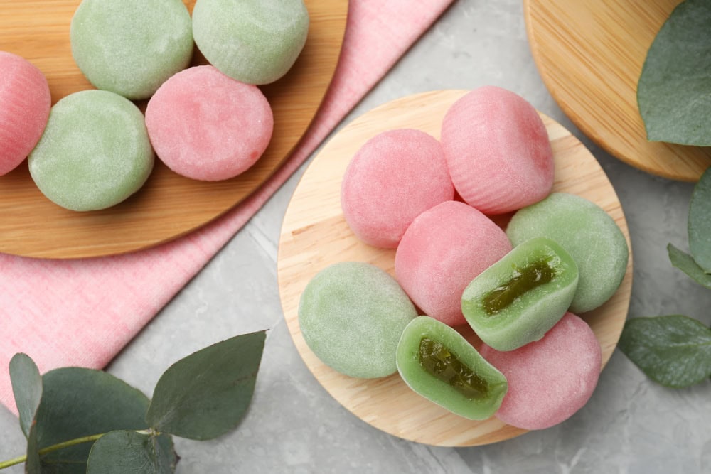 Many different delicious mochi on grey table