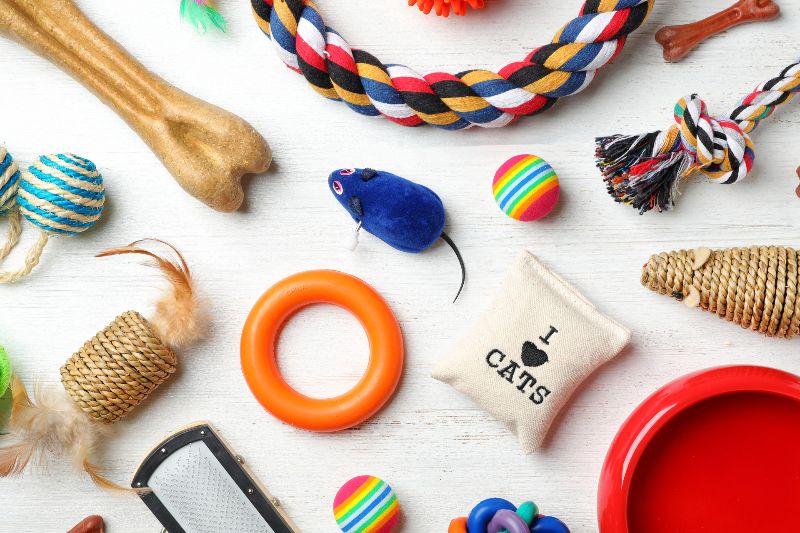 a collection of cat and dog toys on white surface