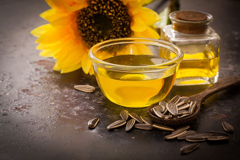 Sunflower oil in bottle glass with seed