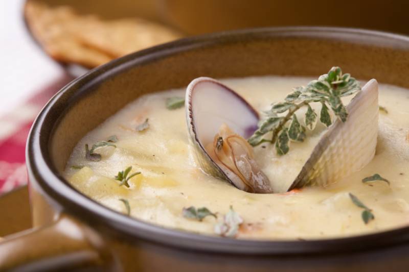 bowl of hot delicious clam chowder garnished with fresh thyme
