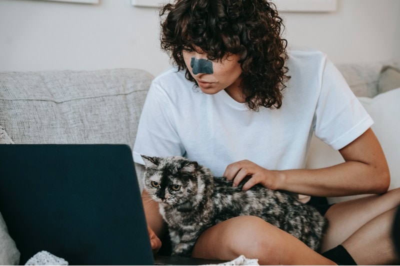 A cat mirroring a woman