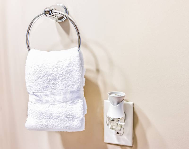 a plug-in air freshener used in the bathroom