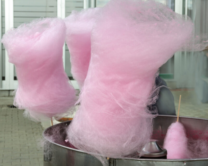 Freshly made pink cotton candy being shown for Sale