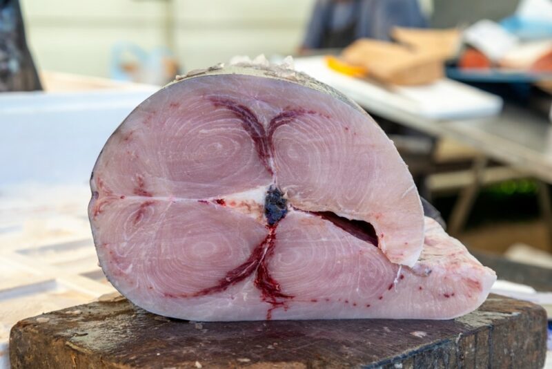 Large piece of raw swordfish on a cutting board