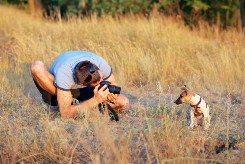 man takes picture of his dog