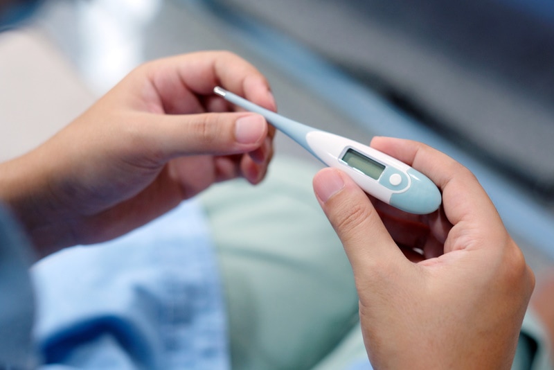 man holding thermometer