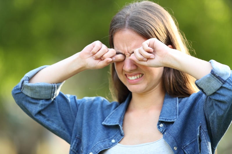 woman having eye irritation