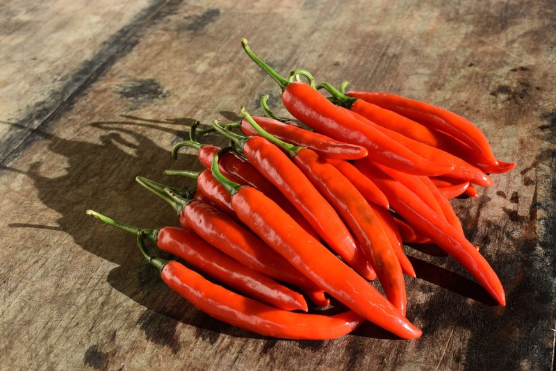 cayenne peppers on wooden table