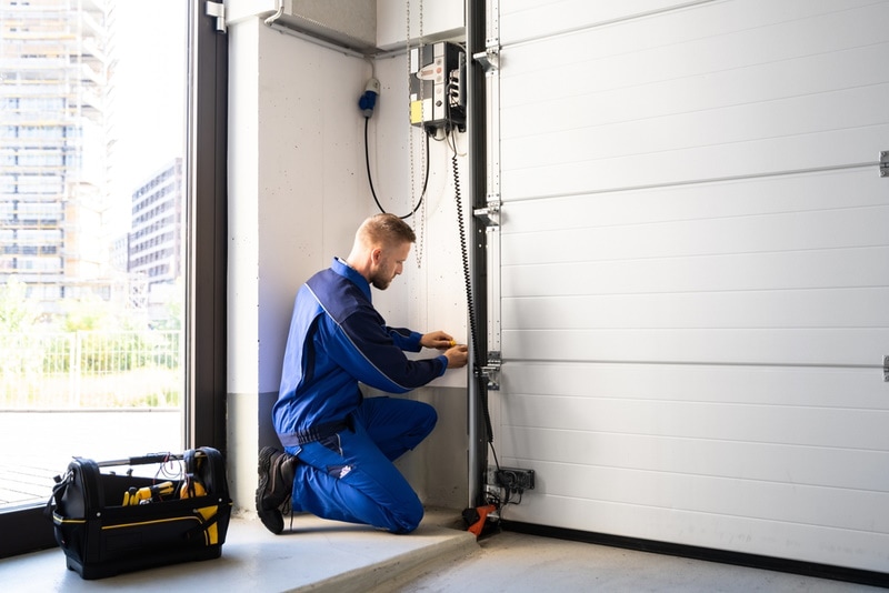man fixing garage door