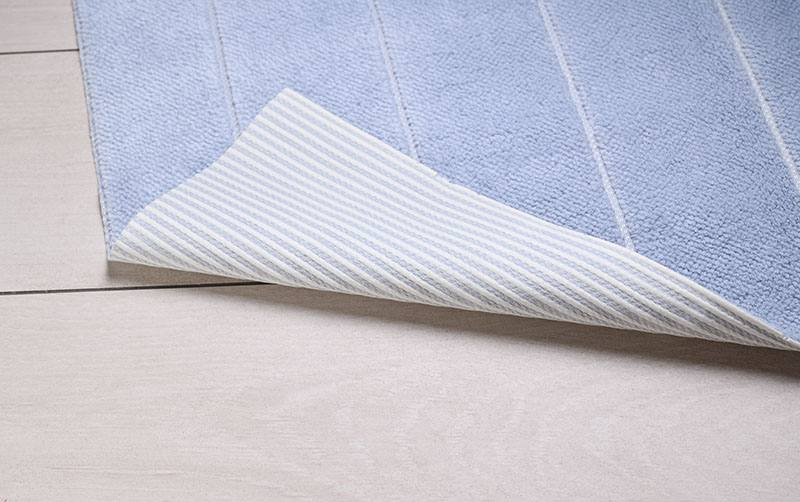Blue rug on white ceramic tile