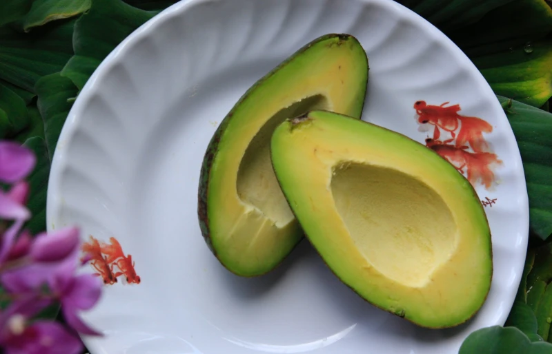 halved avocado on a plate