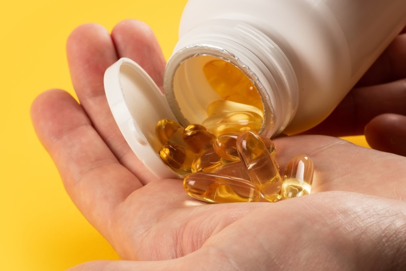 hand holding fish oil capsule
