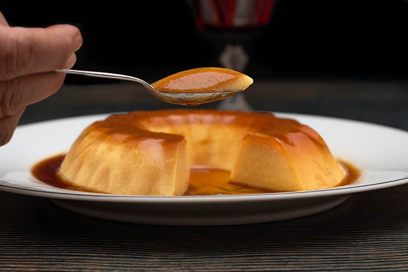 hand scooped a spoonful of custard