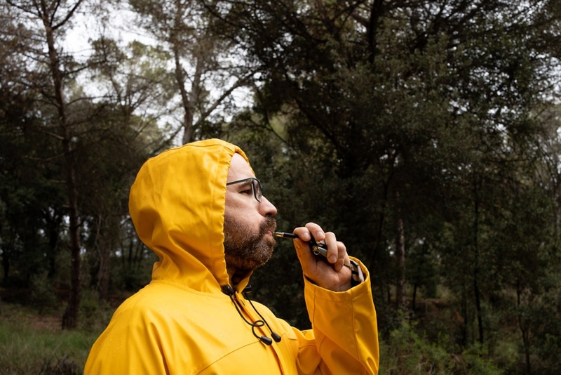 man using dog whistle