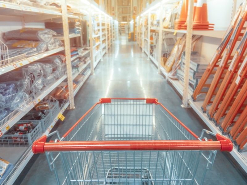 Abstract blurred photo of hardware store with empty shopping cart