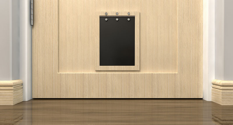 inside view of a black pet flap on a light wood door