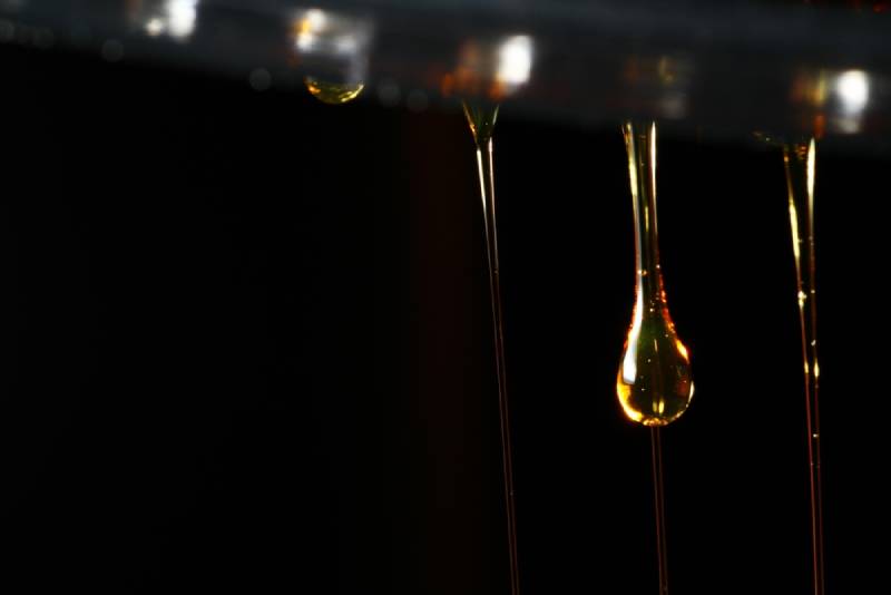 macro shot of lactulose liquid on black background