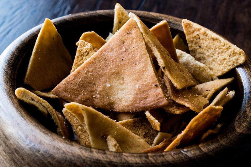 pita chips in a wooden bowl