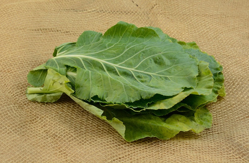 stack of collard greens on burlap