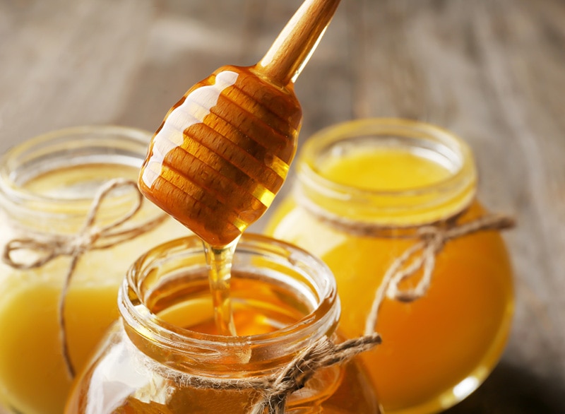 Pouring aromatic honey into jar