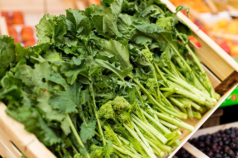 turnip greens in a basket at the market