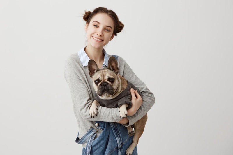 woman holding french bulldog