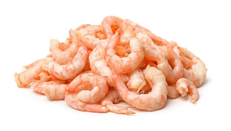 Pile of boiled peeled shrimps isolated on white