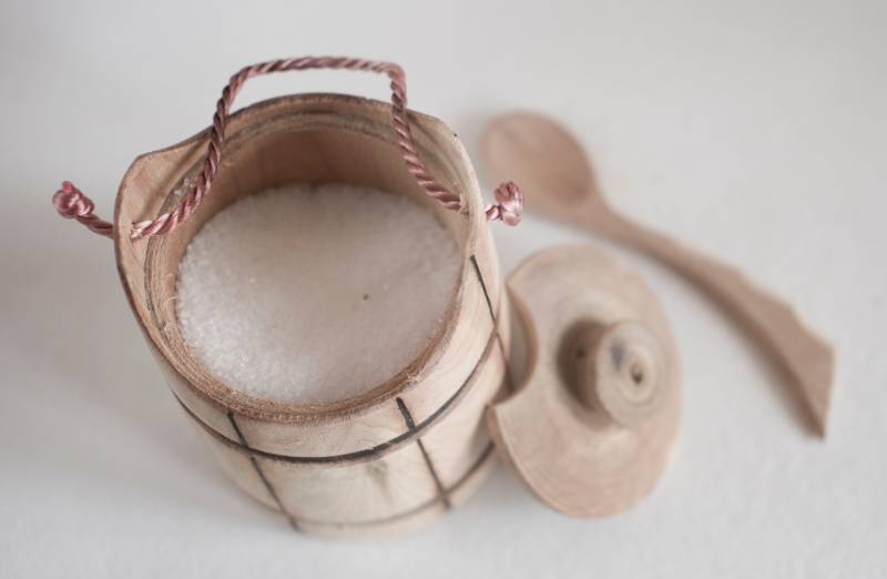 colorless salt in a wooden container