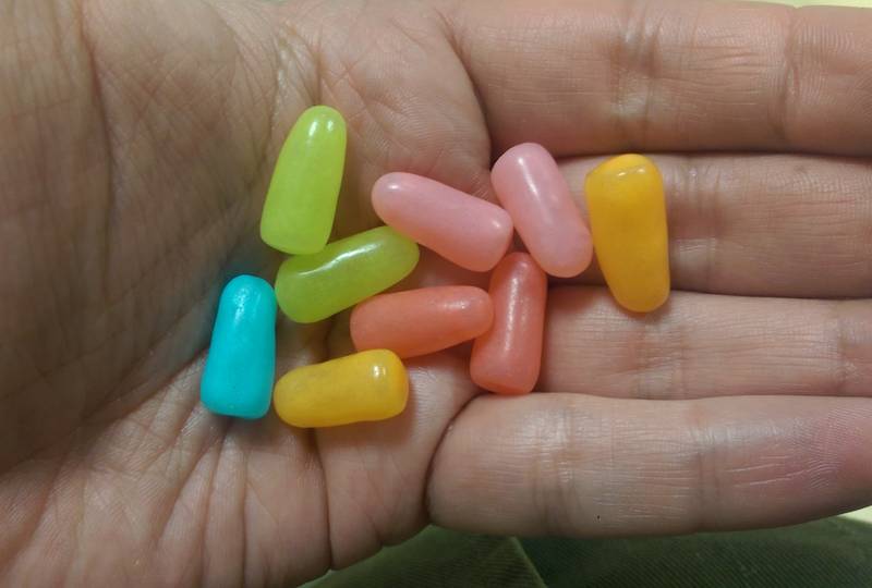 hand holding mike and ike candies