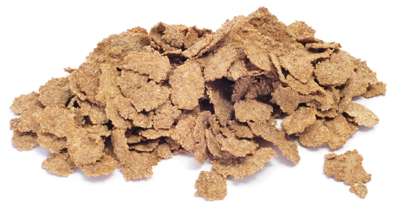 pile of bran flakes on white background
