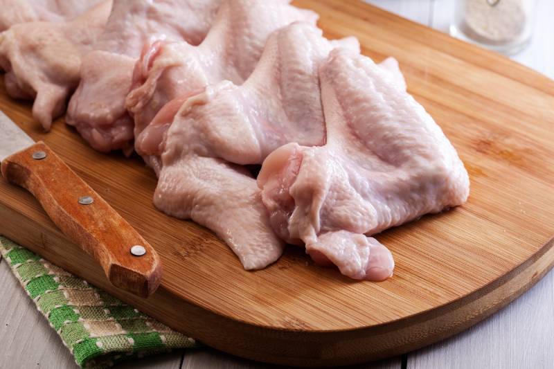 Raw chicken wings on cutting board