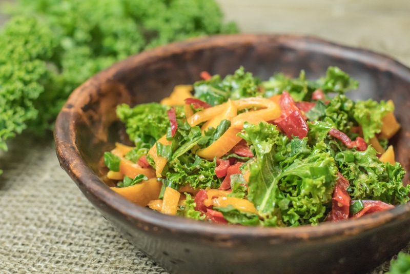 kale and multicolored bell peppers in a bowl