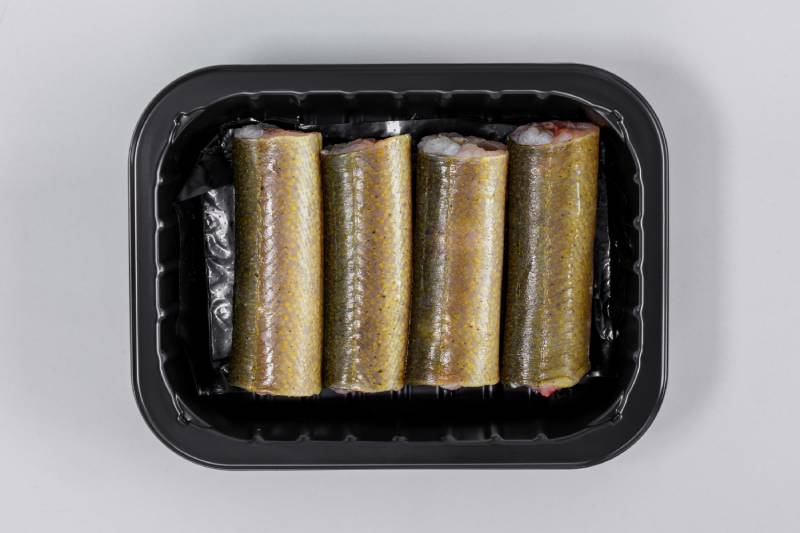 raw eel cut into pieces in a black tray